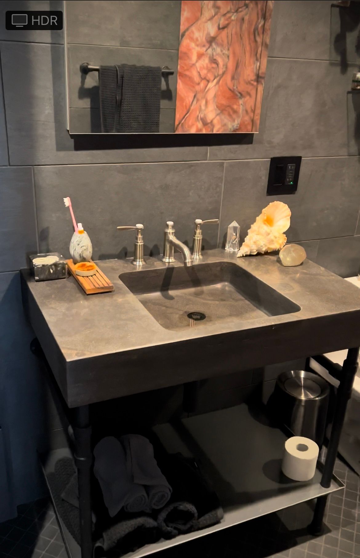 A bathroom sink with a toothbrush and toilet paper on it
