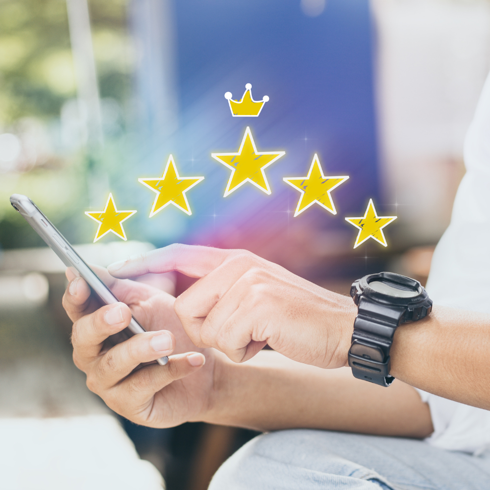 A person using a smartphone with a 3D overlay of five yellow stars and a crown above the screen to indicate high rating.