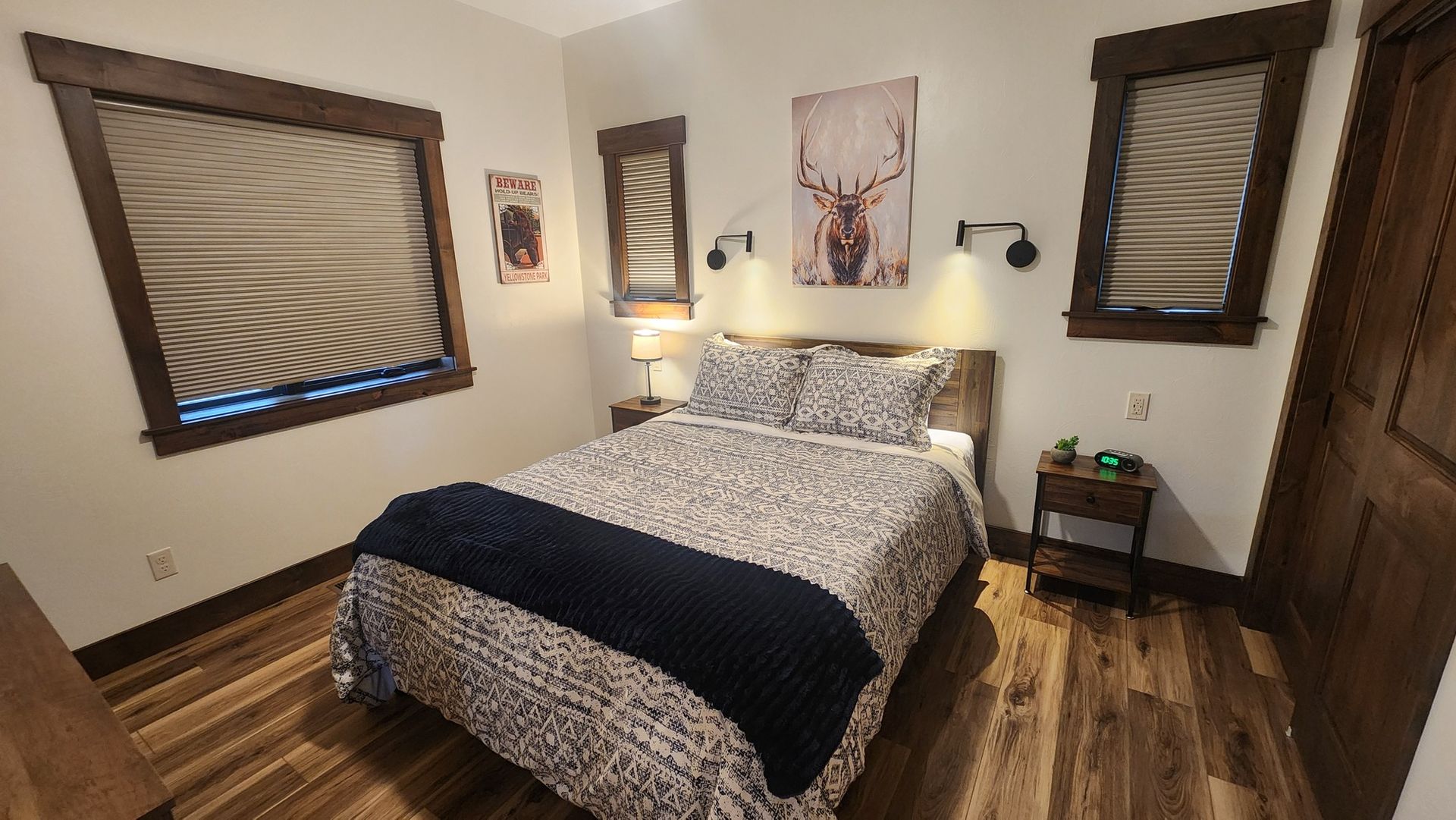 Bedroom with bed, wood flooring, and rustic decor.