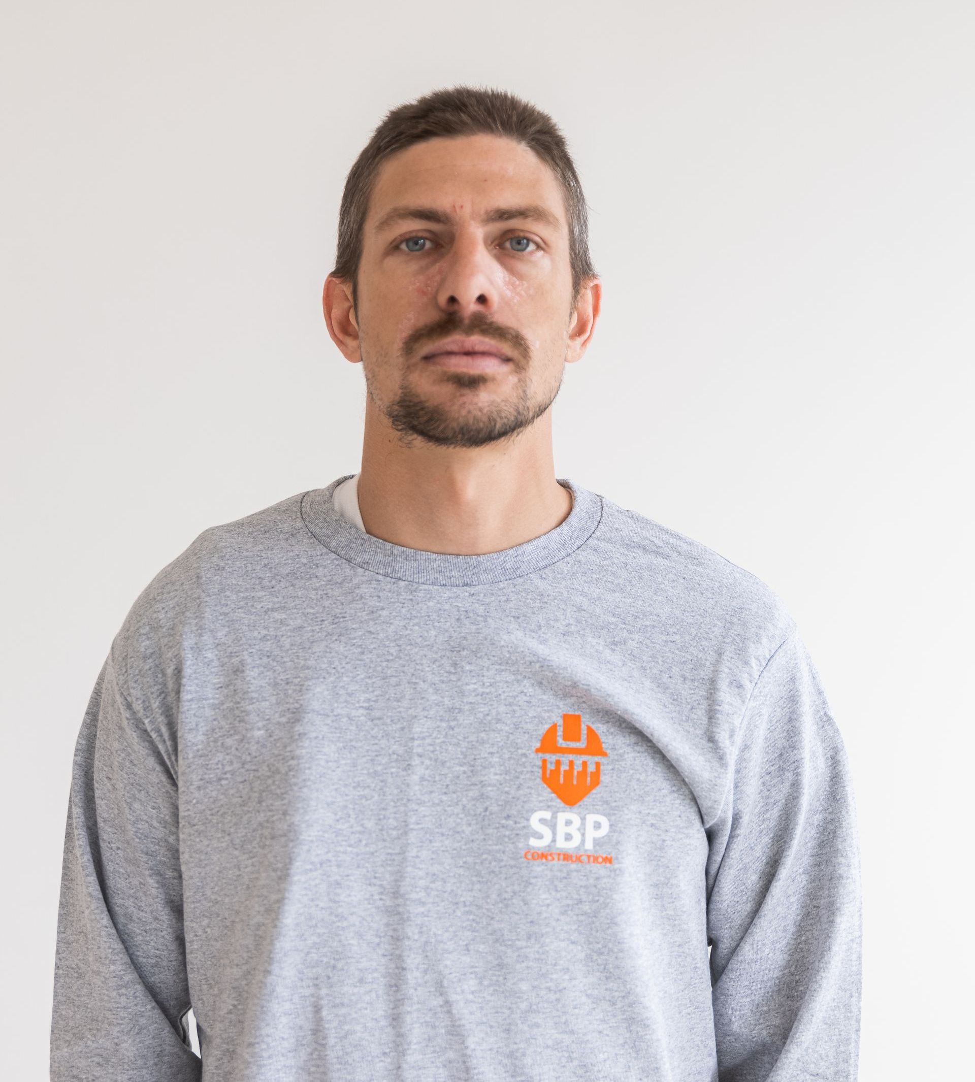 Une icône blanche d'une personne sans visage sur fond gris.