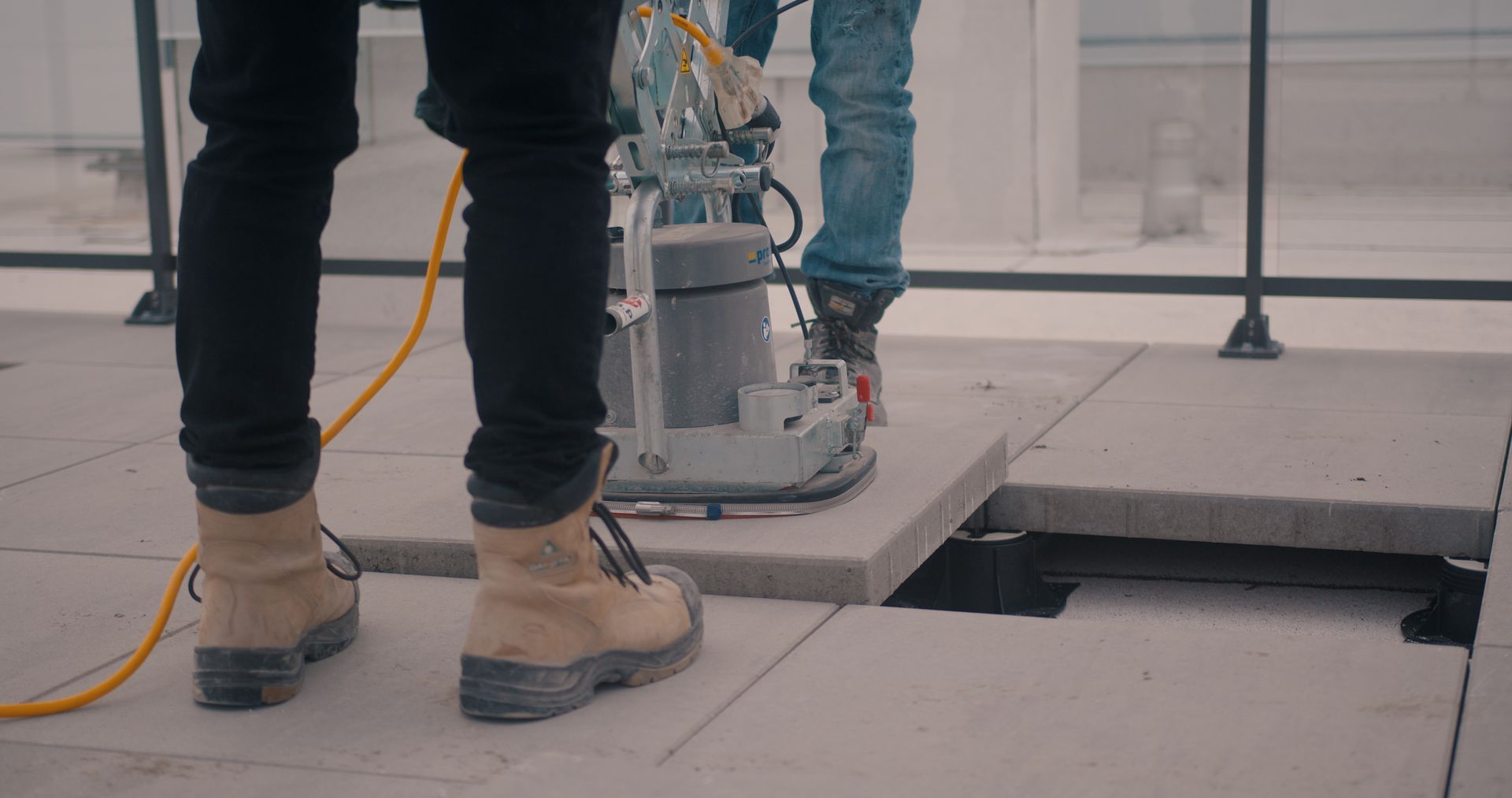 Un homme utilise une machine pour percer un trou dans le sol.
