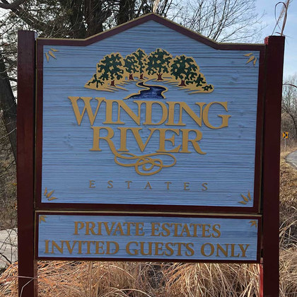A sign for winding river estates says private estates invited guests only