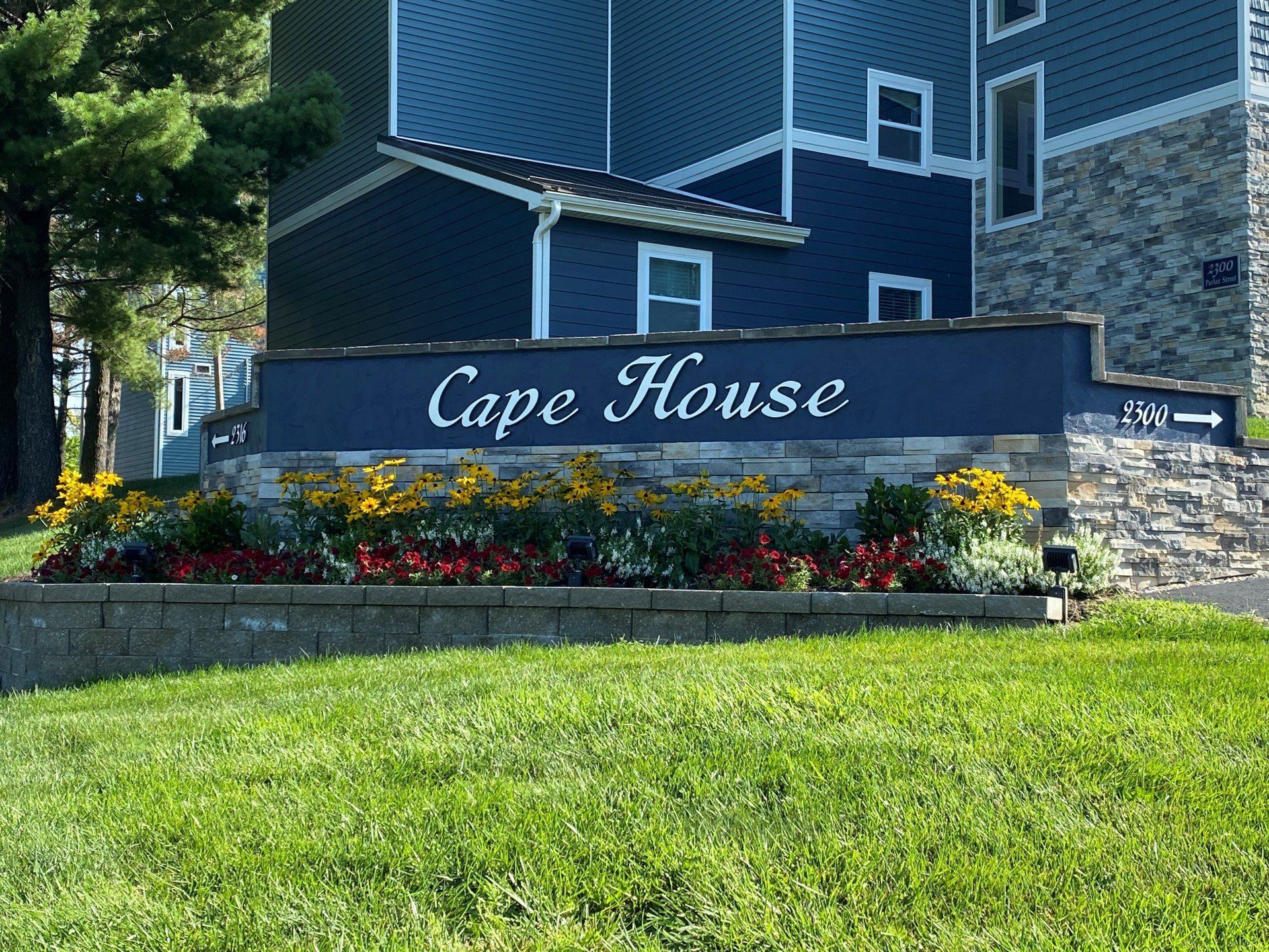 A blue building with a sign that says cape house