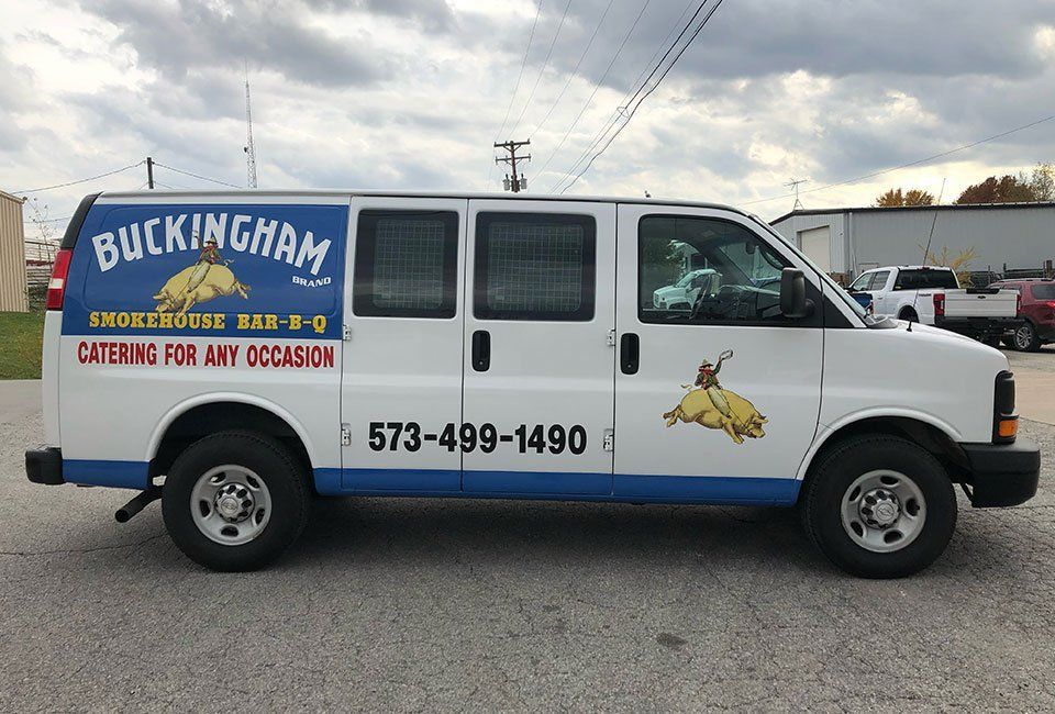 A buckingham van is parked in a parking lot.