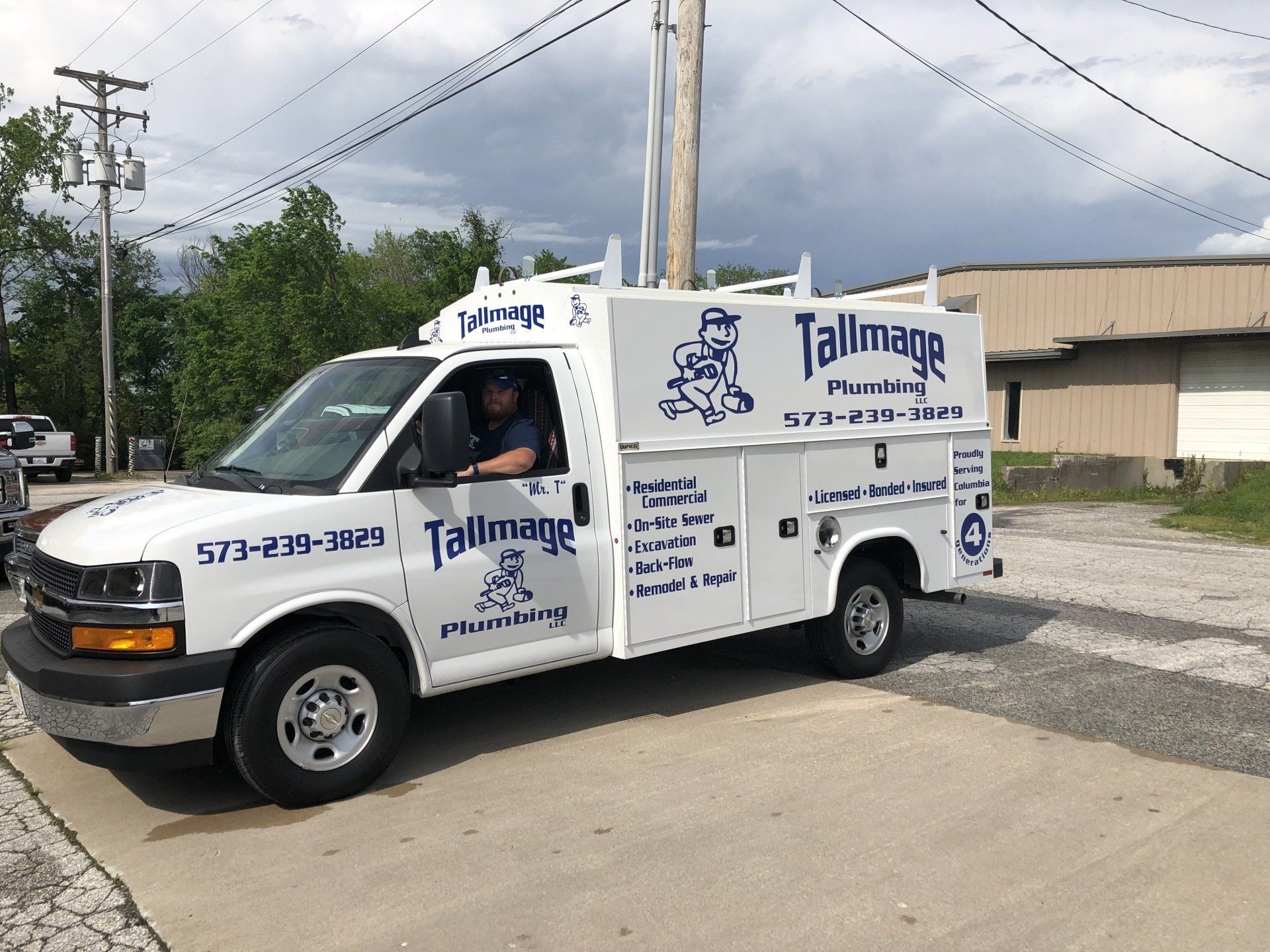 A tallman 's truck is parked on the side of the road