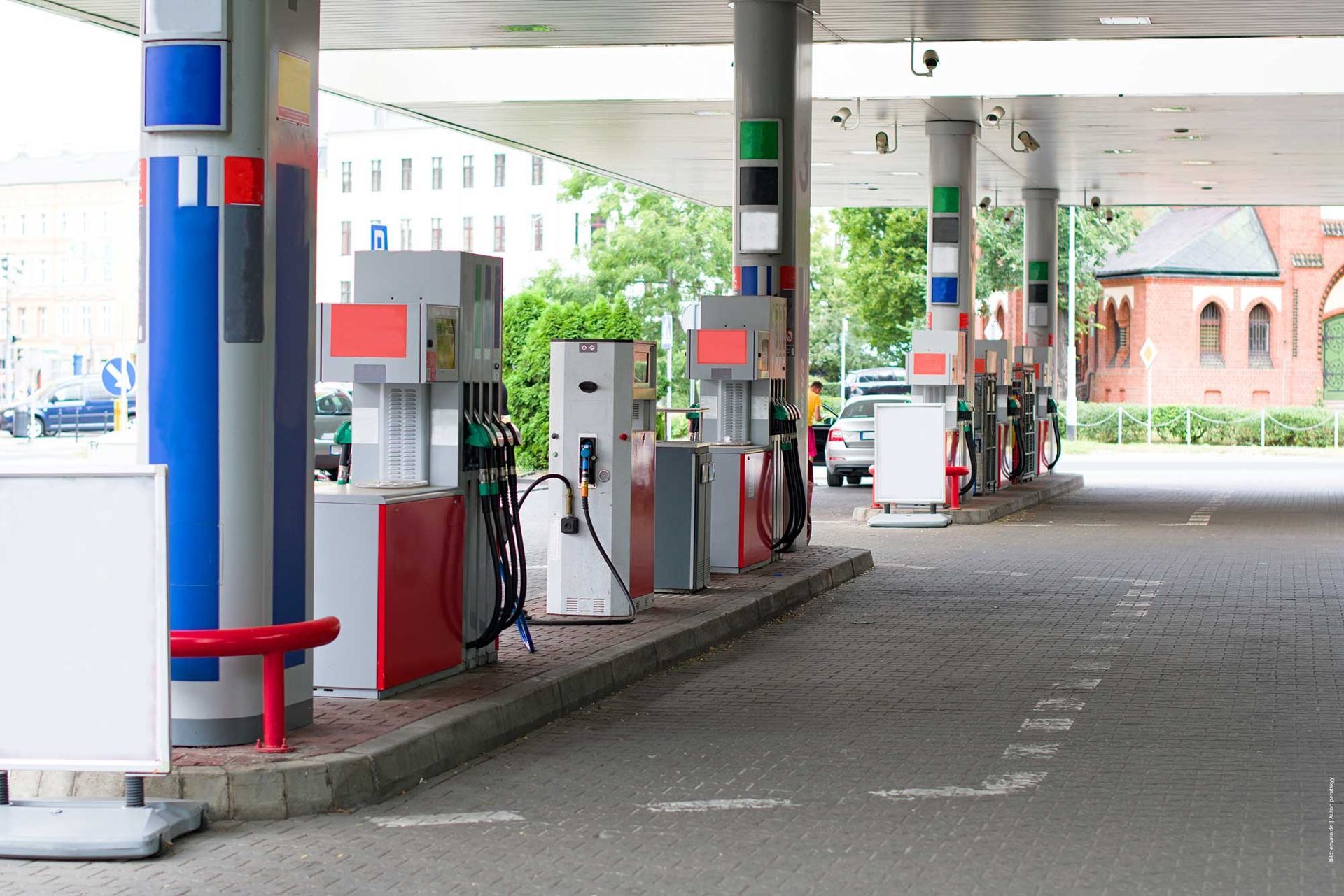 In einer Tankstelle stehen mehrere Zapfsäulen in einer Reihe.