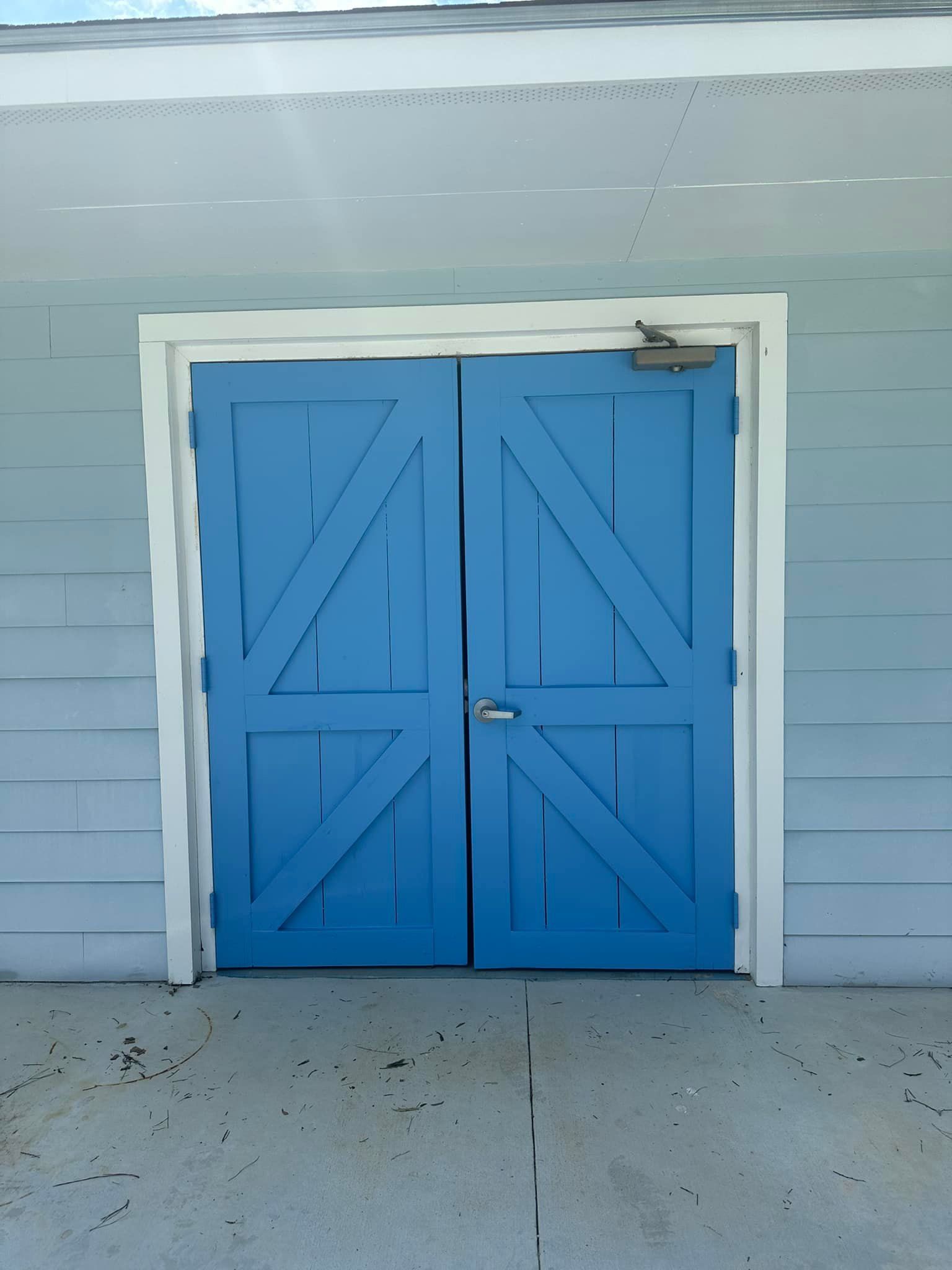A pair of blue barn doors on a building