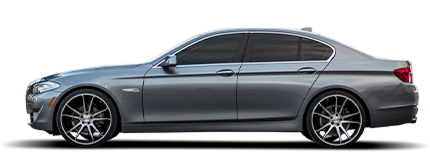 Side view of a silver sedan car with black alloy wheels on a white background | Tinley Auto Repair & Towing Inc