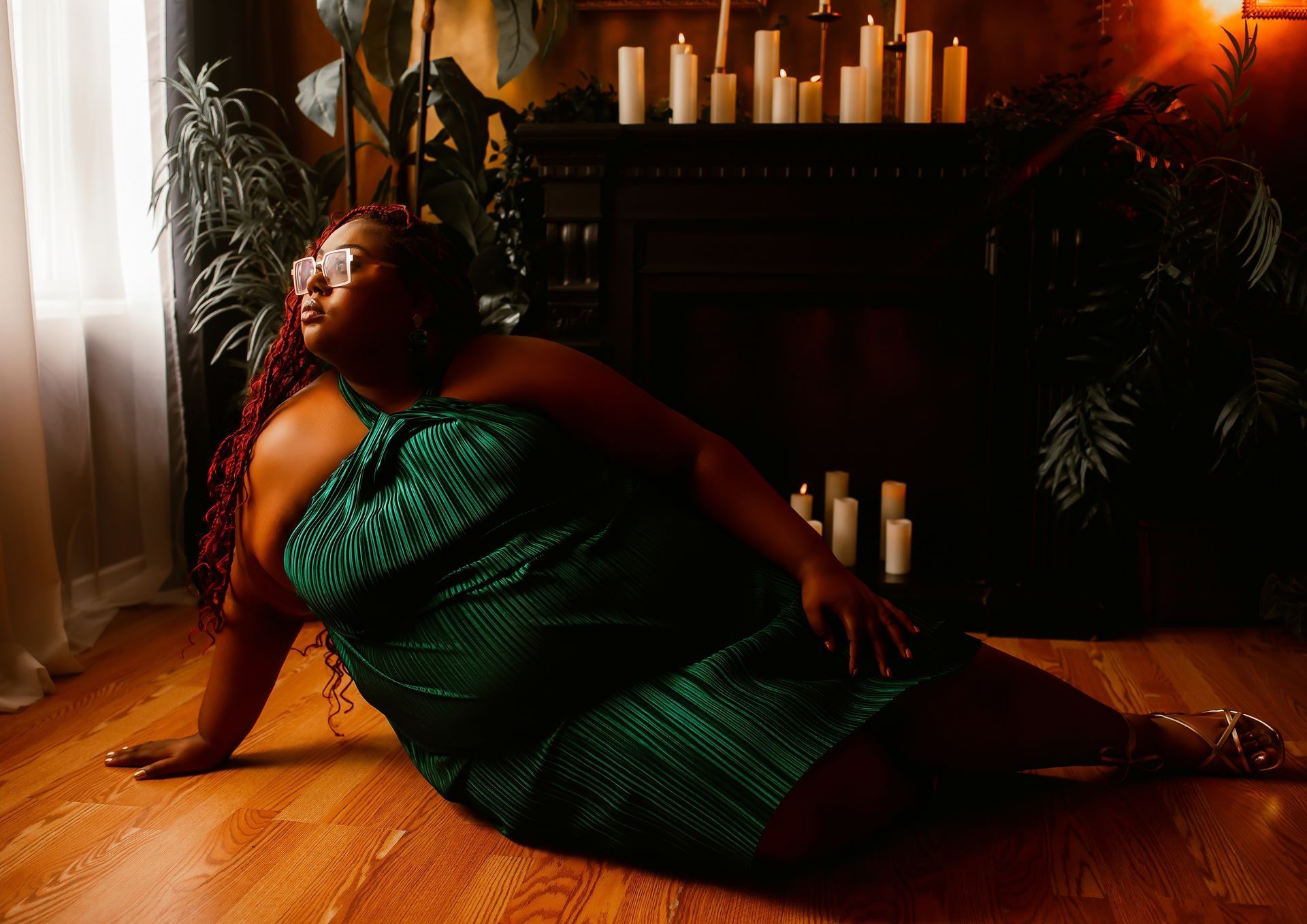 A woman in blue lingerie is laying on the floor in front of a mirror.