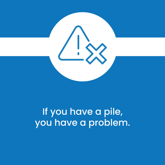 A blue sign that says if you have a pile you have a problem