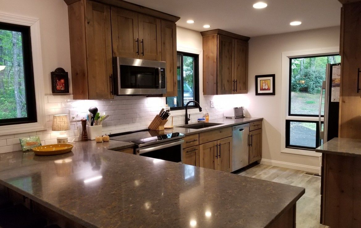 Kitchen with brown wooden cabinets, stainless steel appliances, and a gray countertop.