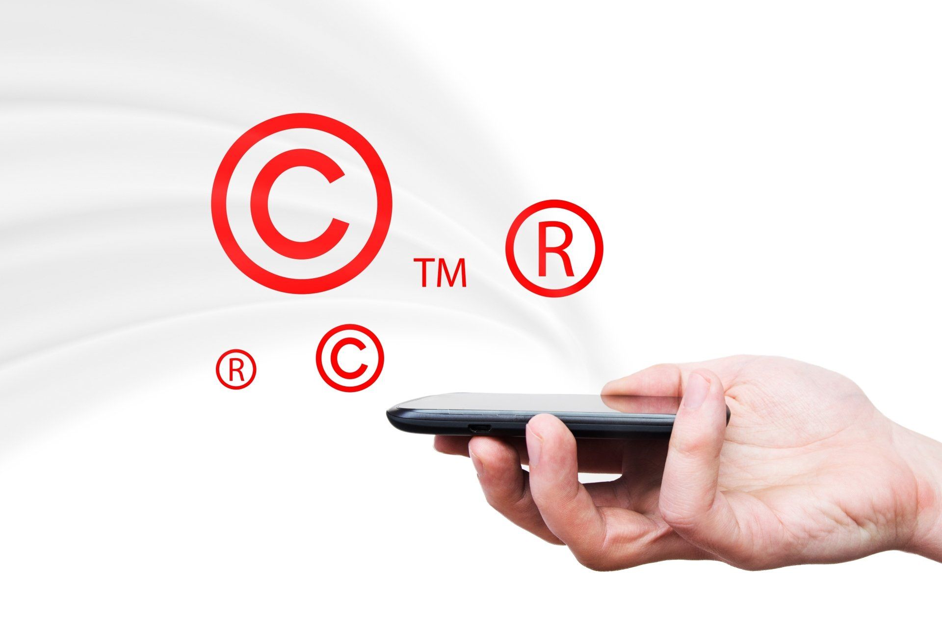 Copyright, trademark symbols flying from smartphone. Security and piracy composition
