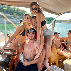A group of people are posing for a picture on a boat.