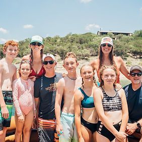 A group of people are posing for a picture on a boat.