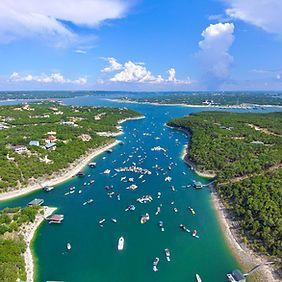 An aerial view of a large body of water filled with boats.
