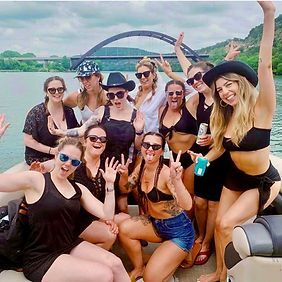 A group of women are posing for a picture on a boat.