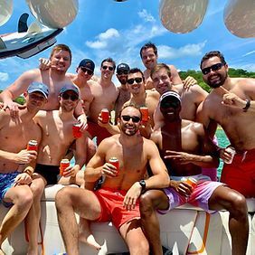 A group of men are posing for a picture on a boat.