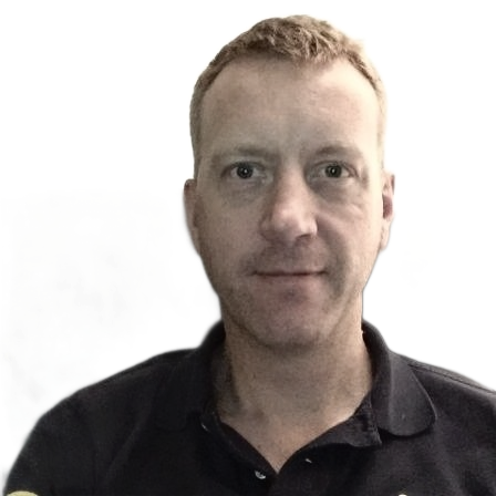 Man with light hair, wearing a dark blue collared shirt, looking at the camera.