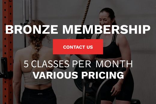 Two women are standing next to each other in a gym.