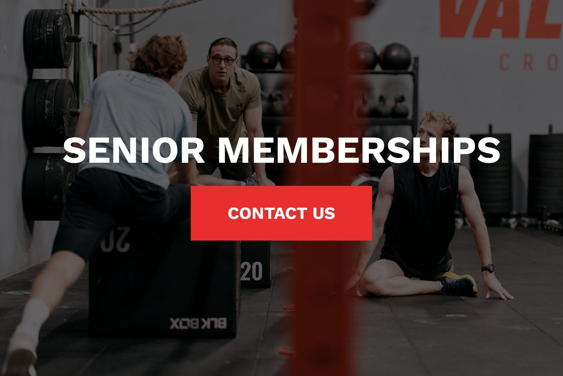 A group of men are doing exercises in a gym.