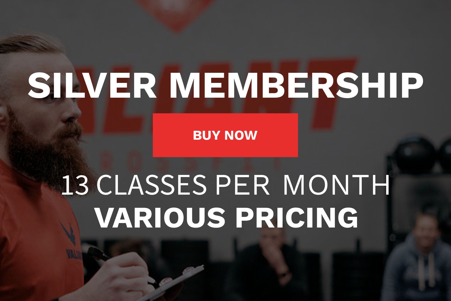A man with a beard is holding a clipboard in front of a sign that says silver membership