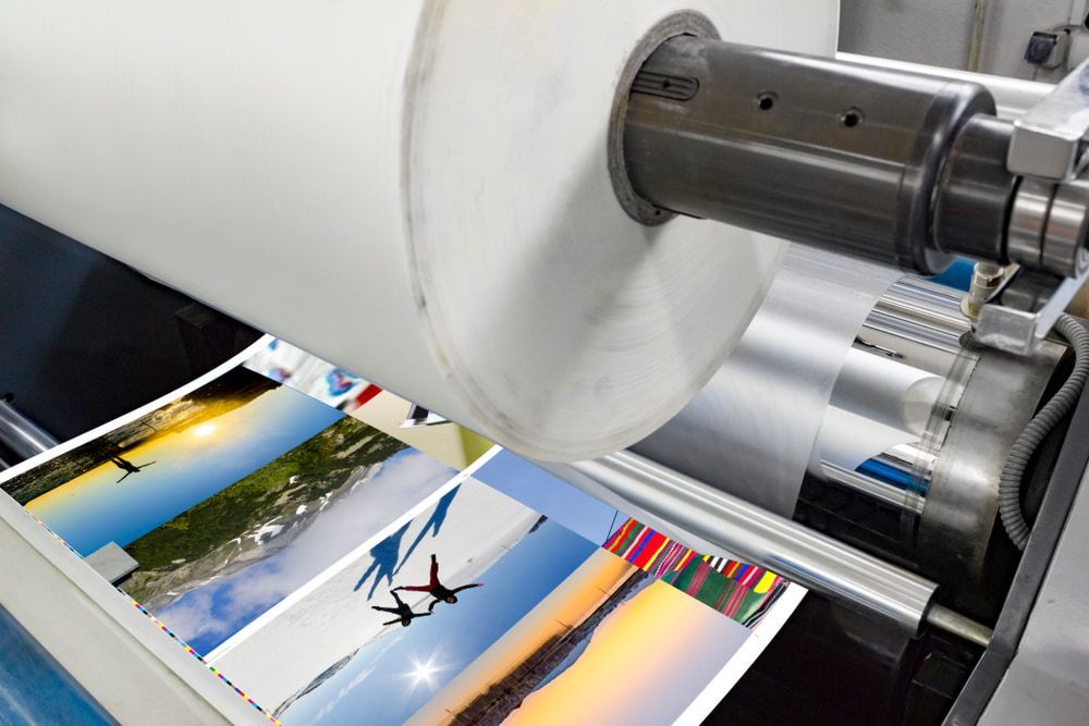 A Machine Is Printing Pictures On A Roll Of Paper — Armidale Colour Copy Centre In Armidale, NSW