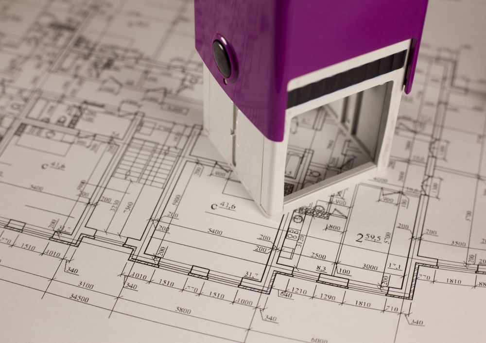 A Purple And White Stamp Is Sitting On Top Of A Blueprint — Armidale Colour Copy Centre In Armidale, NSW