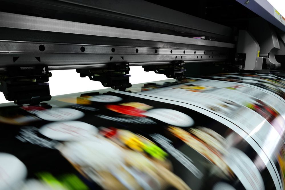 A Large Printing Machine Is Printing A Large Sheet Of Paper — Armidale Colour Copy Centre In Armidale, NSW