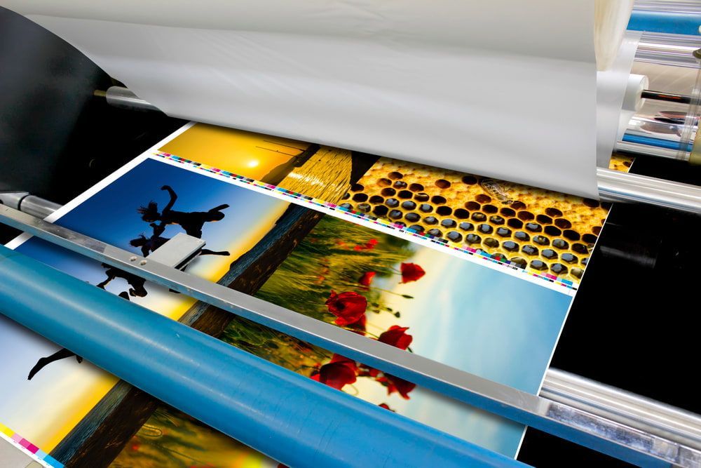 A Printer Is Printing A Bunch Of Pictures On A Roll — Armidale Colour Copy Centre In Armidale, NSW