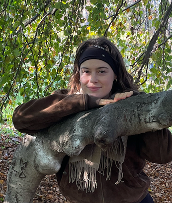 Andie Turner standing in nature.