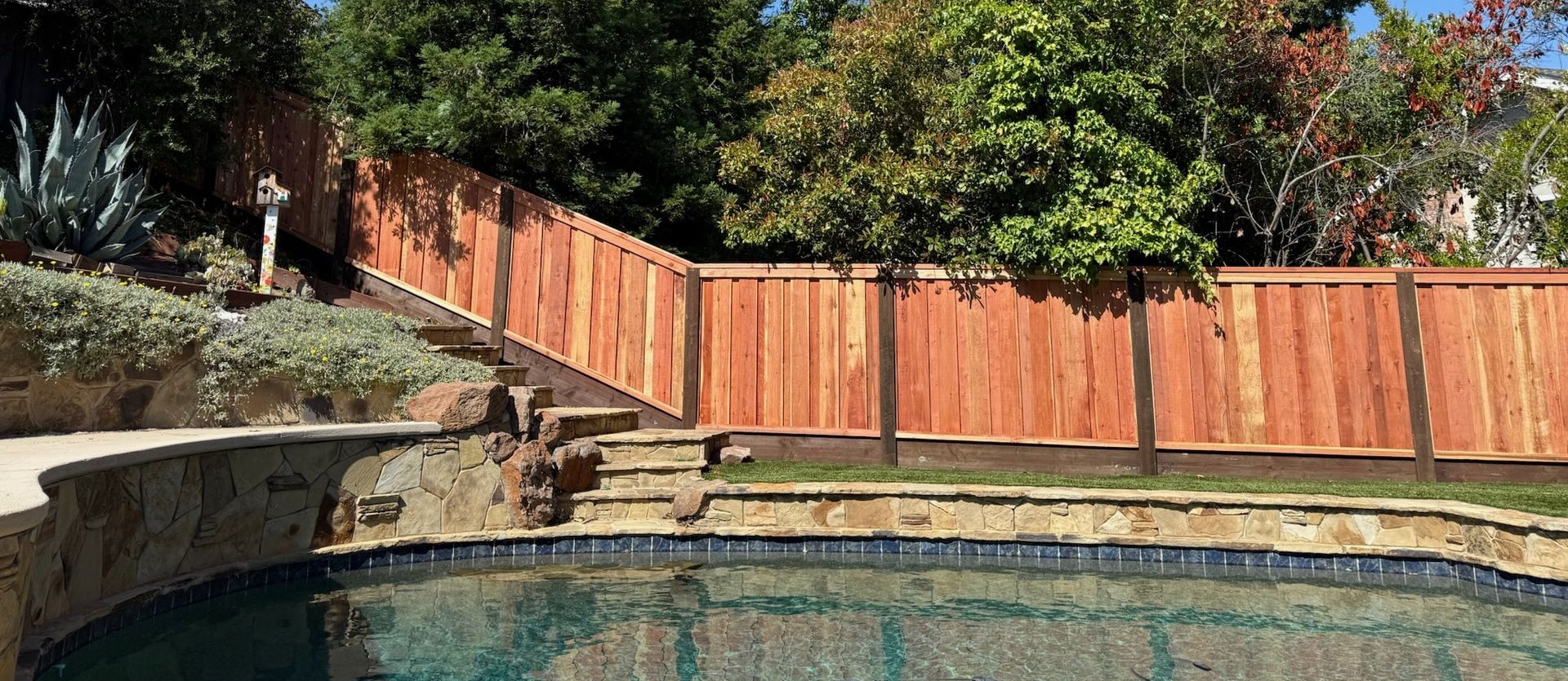Wooden fence along a sloping yard. Best Fencing Contractor in Pleasanton