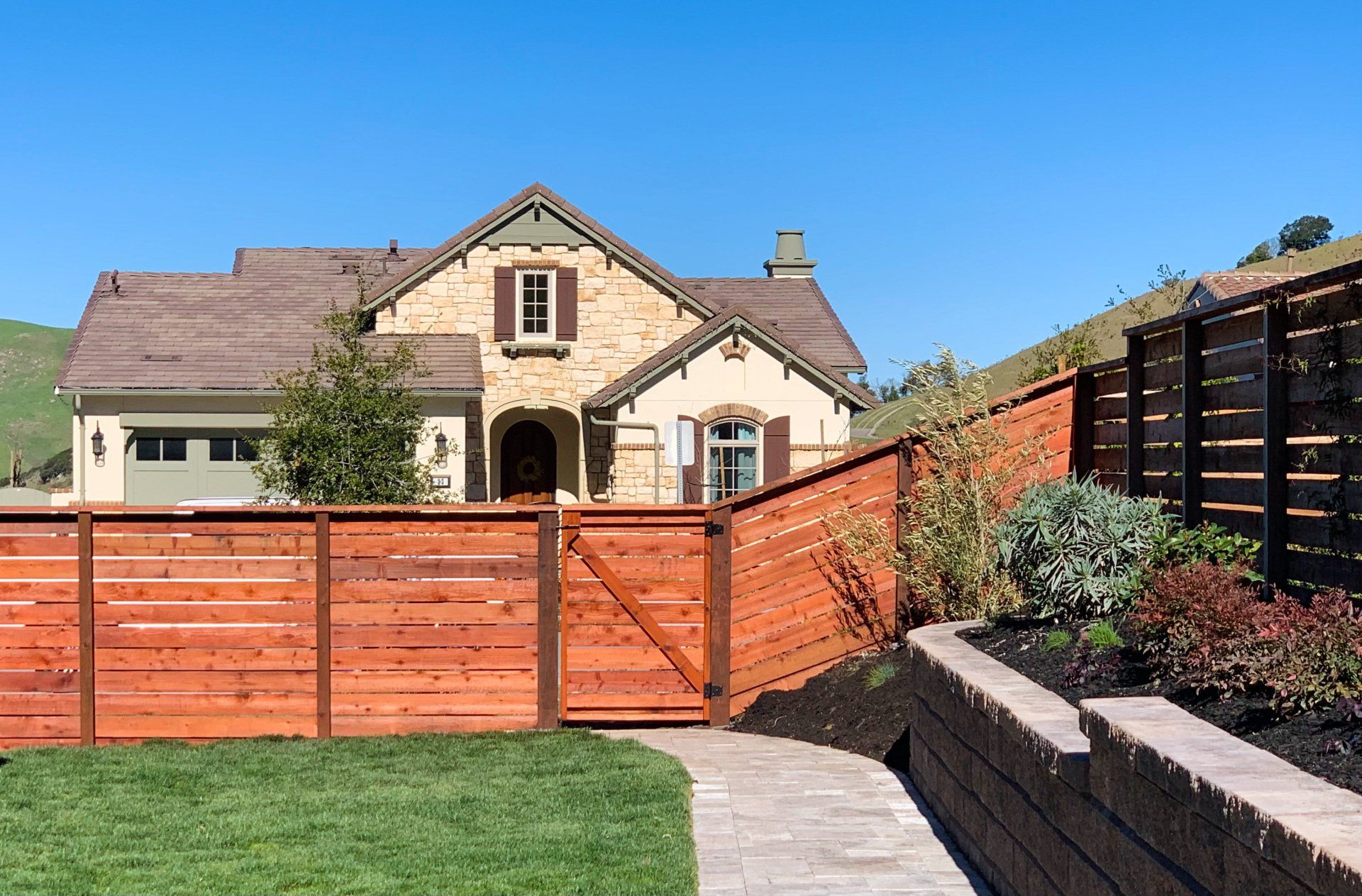 A house with a wooden fence in front of it.