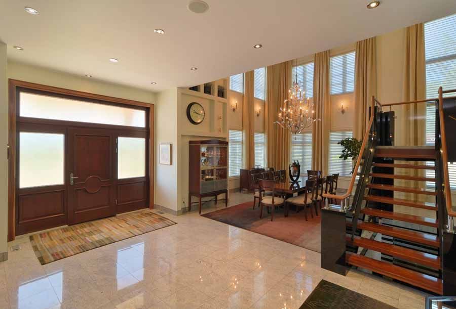 A large room with a clock on the wall and a staircase