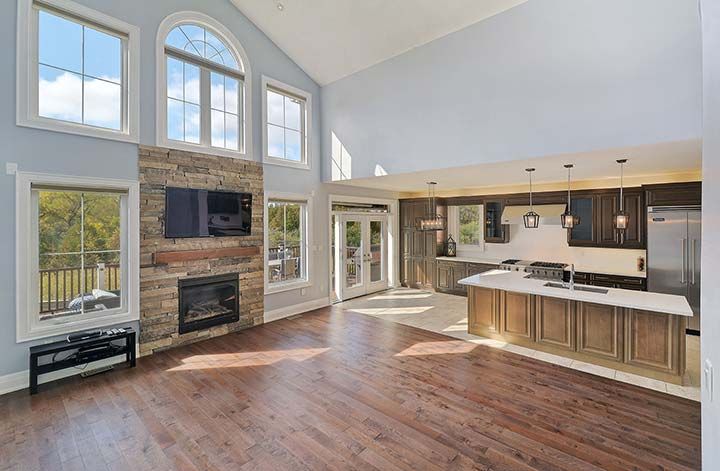 A living room with hardwood floors and a fireplace in a house.