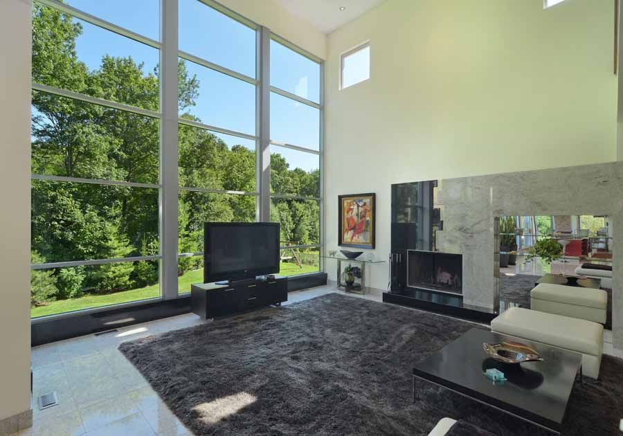 A living room with a fireplace and a flat screen tv