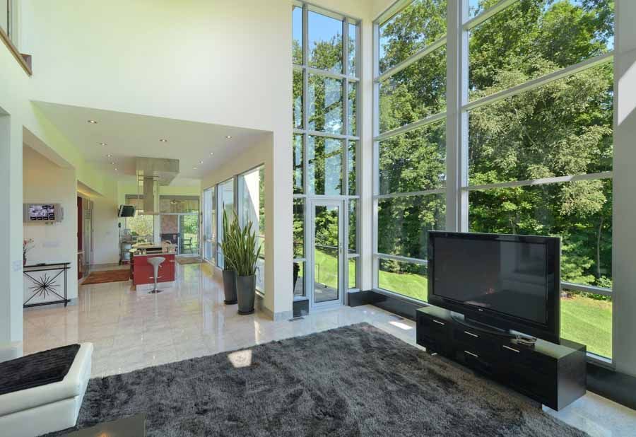 A living room with lots of windows and a flat screen tv