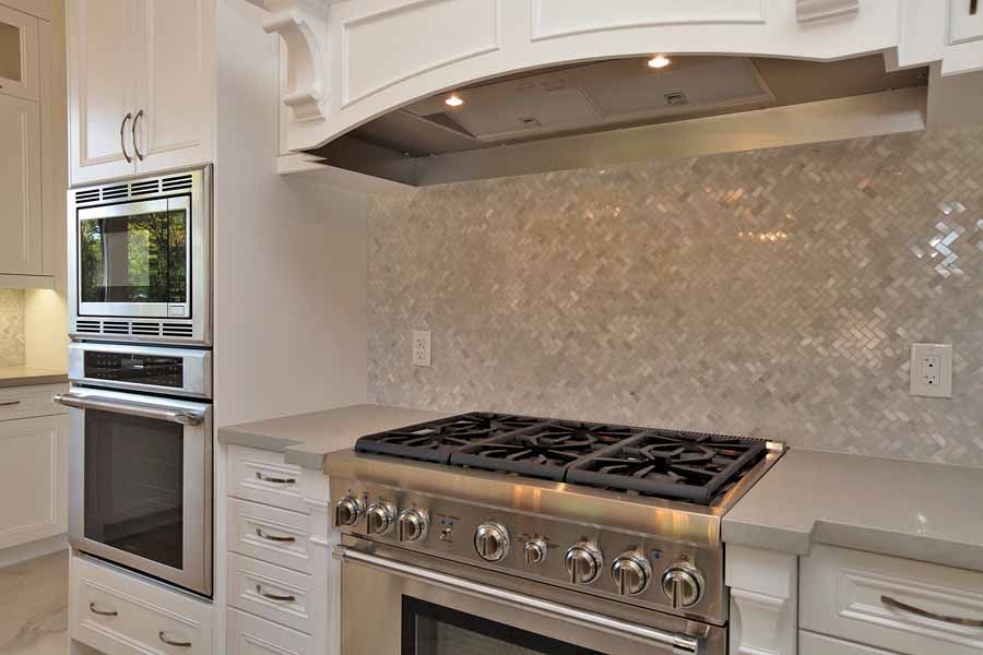 A kitchen with a stove , oven and microwave.