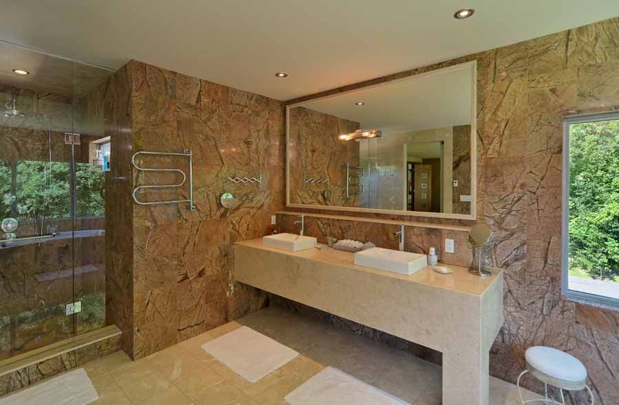 A bathroom with two sinks and a large mirror.