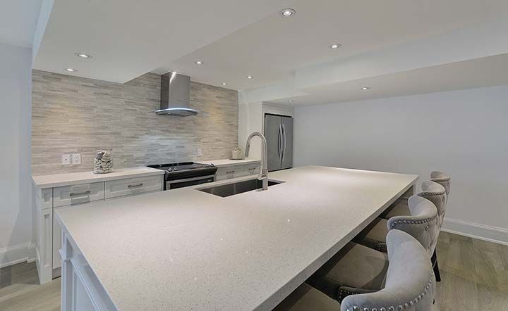 There is a large island in the middle of the kitchen.