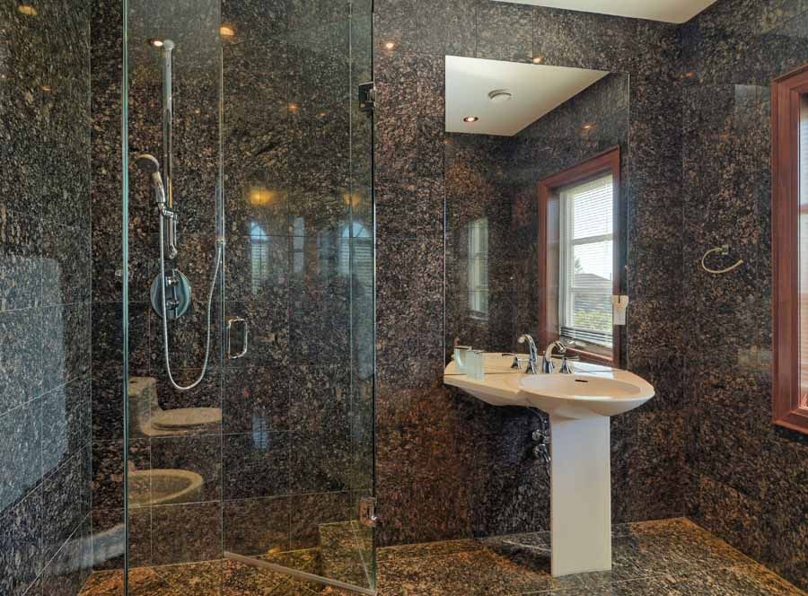 A bathroom with a sink and a walk in shower