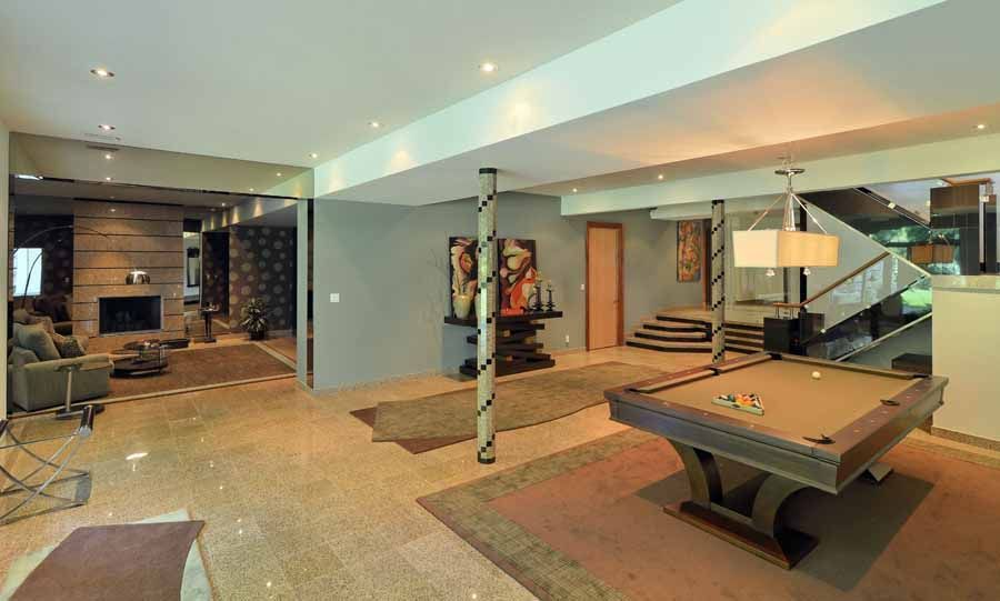 There is a pool table in the middle of the room.