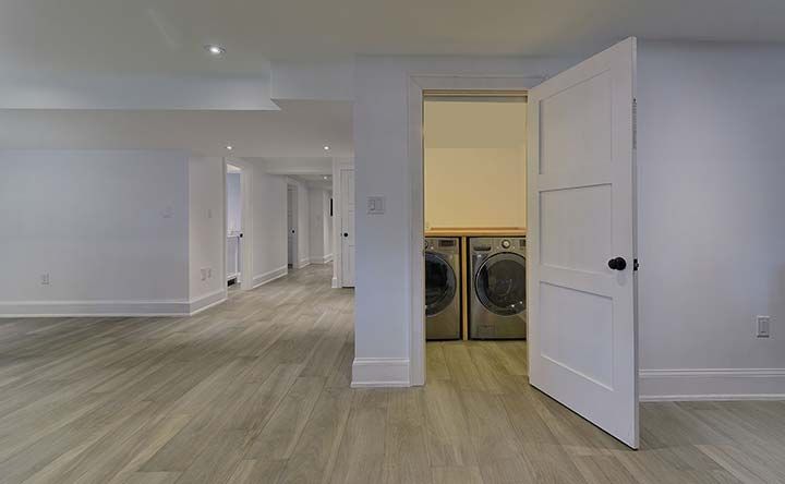 There is a laundry room with a washer and dryer in it.