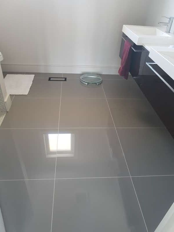 A bathroom with two sinks and a scale on the floor.