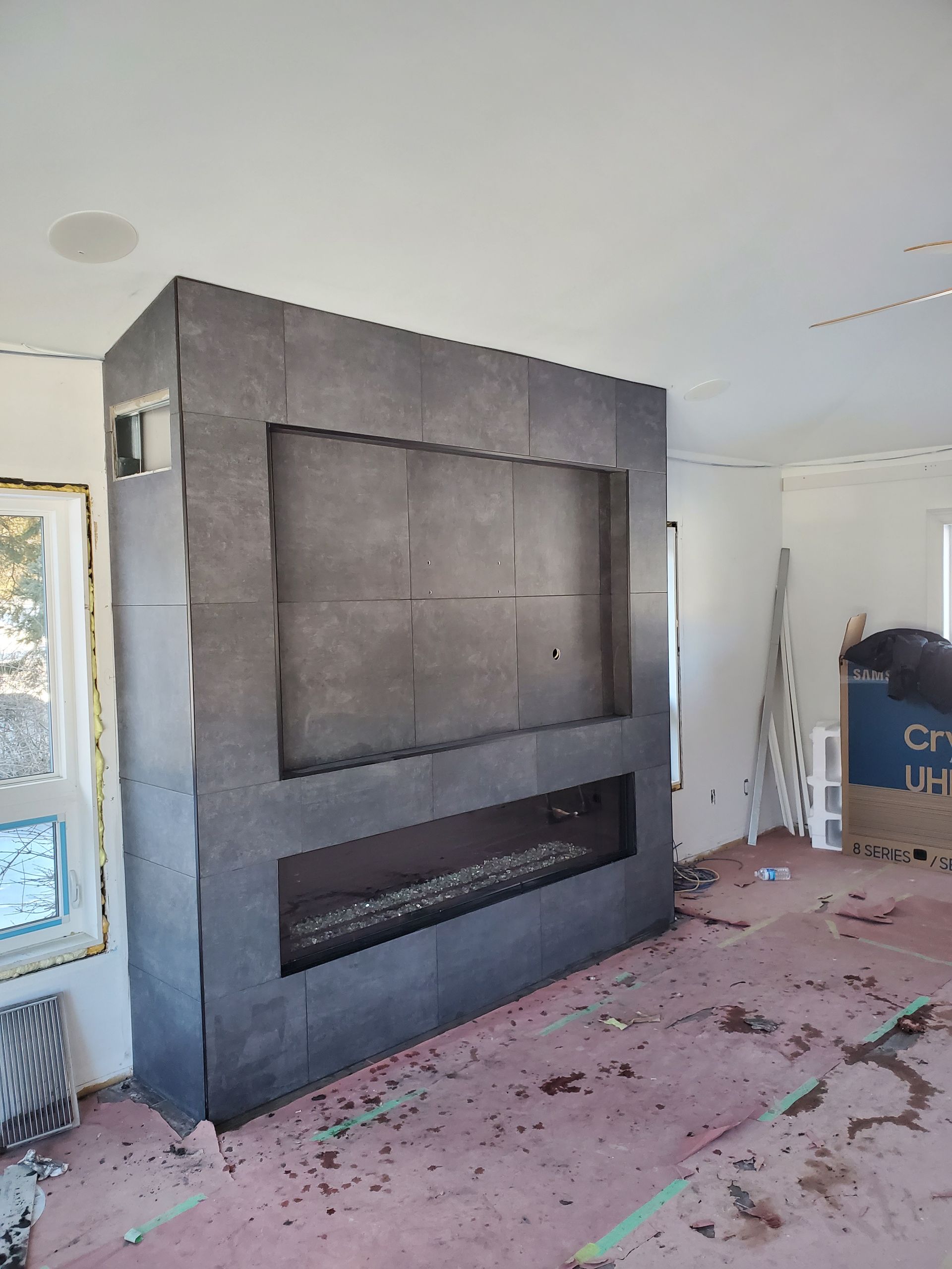 A living room with a fireplace and a flat screen tv.