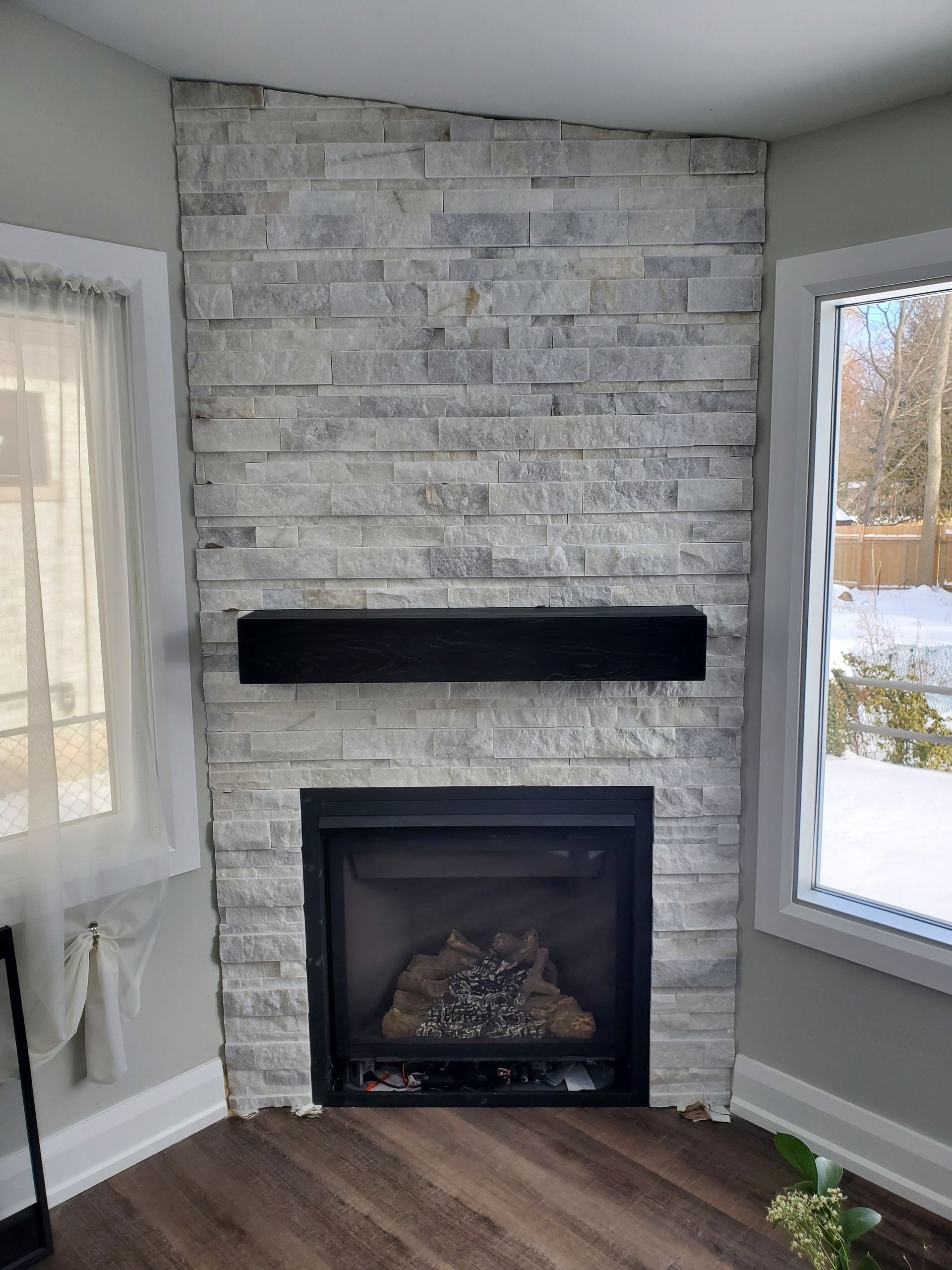A living room with a fireplace and a window.