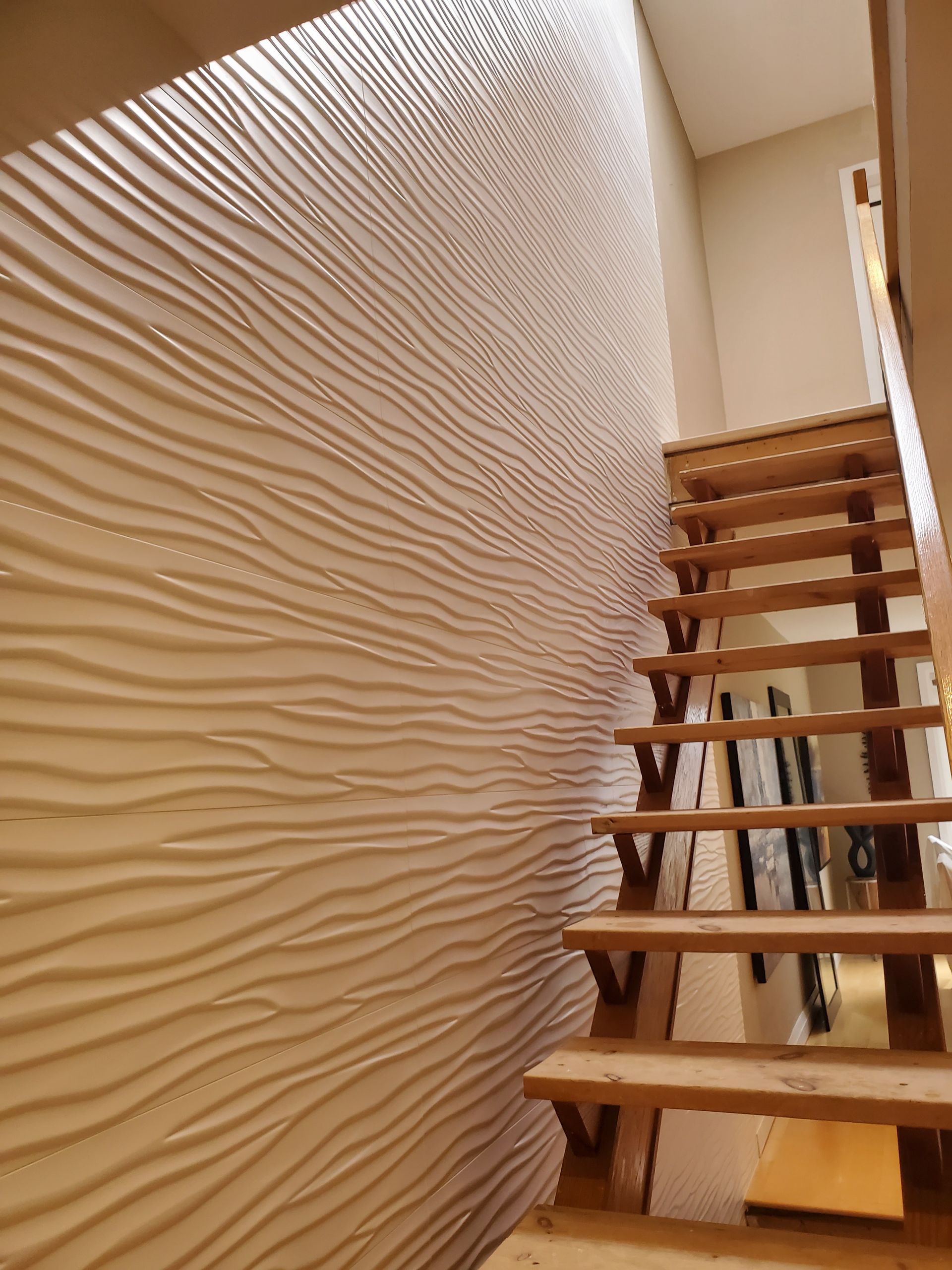 A wooden staircase leading up to the second floor of a house.