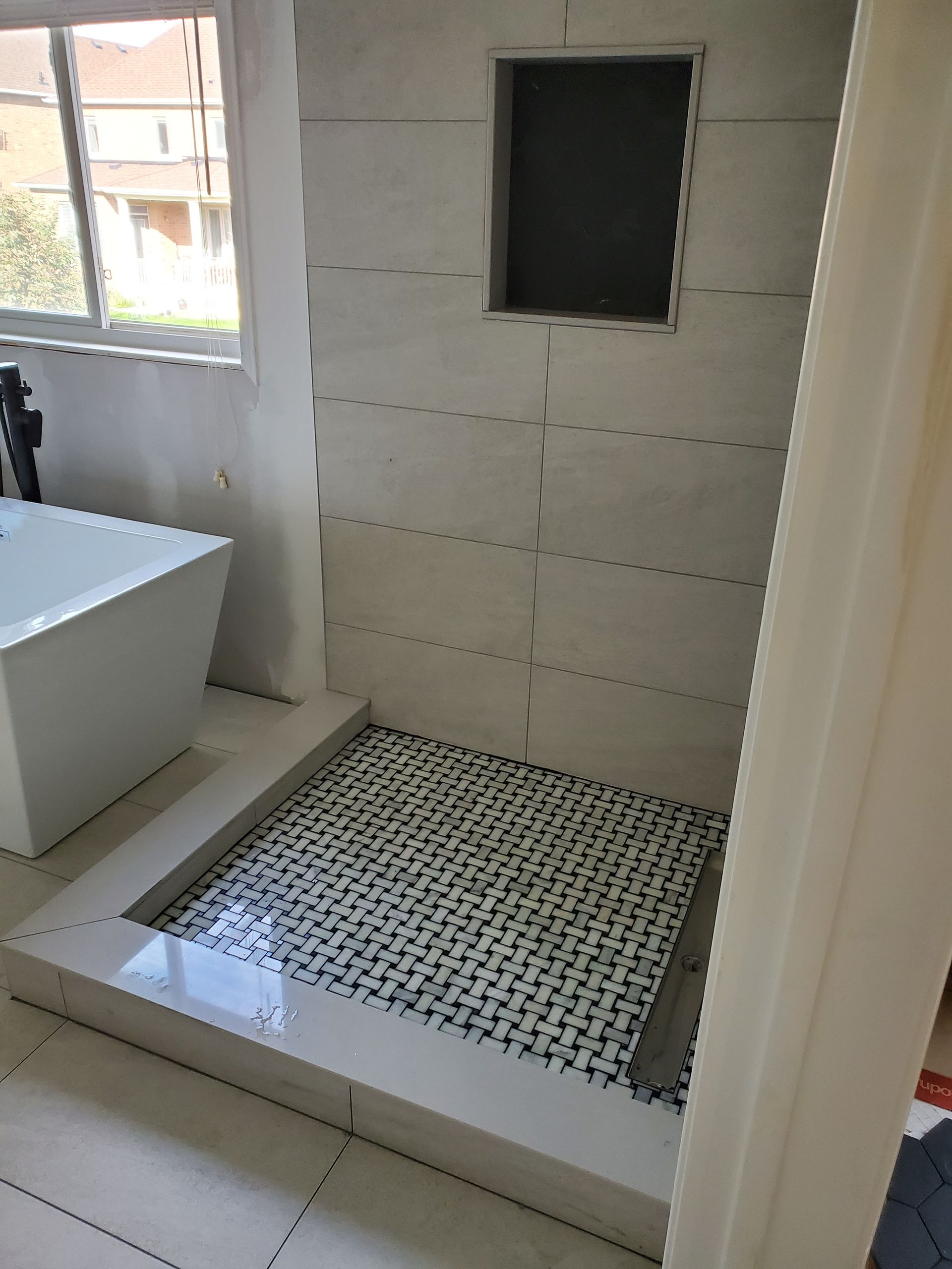 A bathroom with a bathtub and a walk in shower.