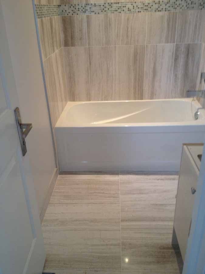 A bathroom with a bathtub and a sink.