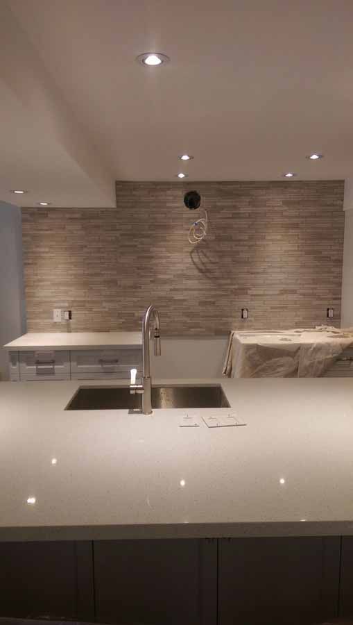 There is a sink in the middle of the kitchen.