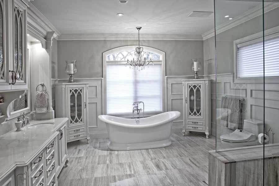 A bathroom with a tub , sink , toilet and shower.